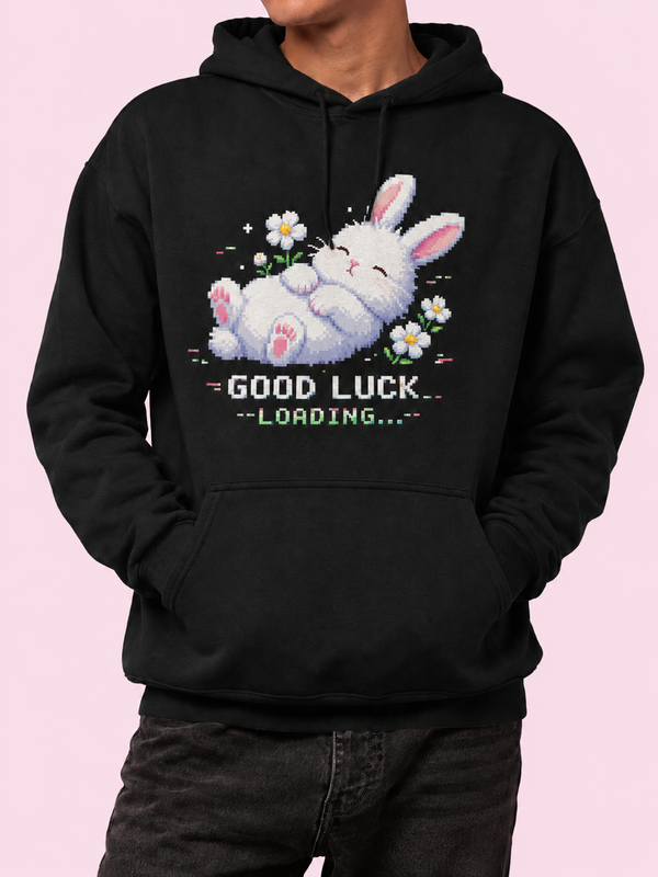 Man wearing the Ruxel Good Luck Loading hoodie in Void Black, front view - pixel-art sleeping white bunny with daisies above GOOD LUCK LOADING text