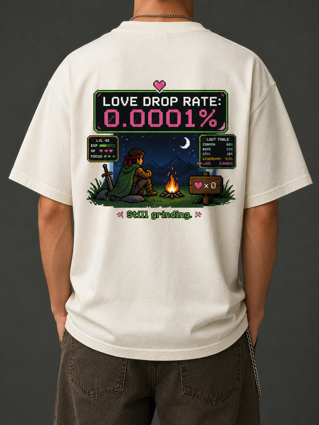 Man wearing the Ruxel Love Drop Rate tee in Cream, back view - pixel RPG loot screen with Love Drop Rate 0.0001%, a campfire hero, stats panel and loot table