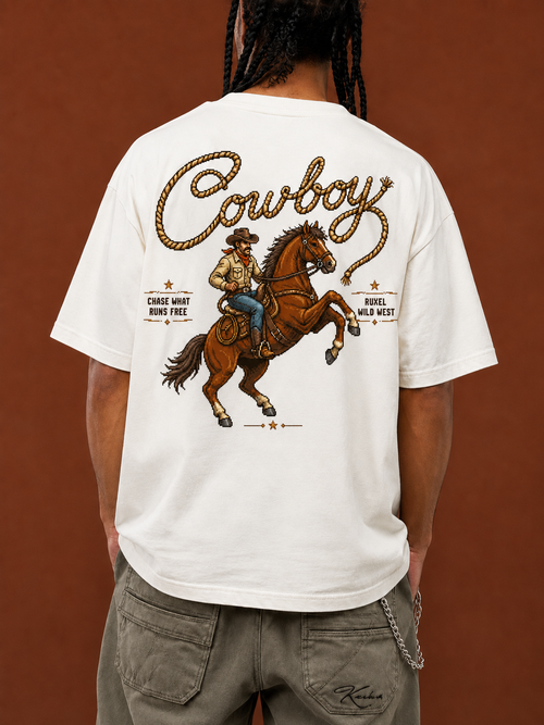 Back of Ruxel Chase What Runs Free tee in Bone - pixel cowboy on a rearing horse with rope-script “Cowboy” and “Chase What Runs Free” text