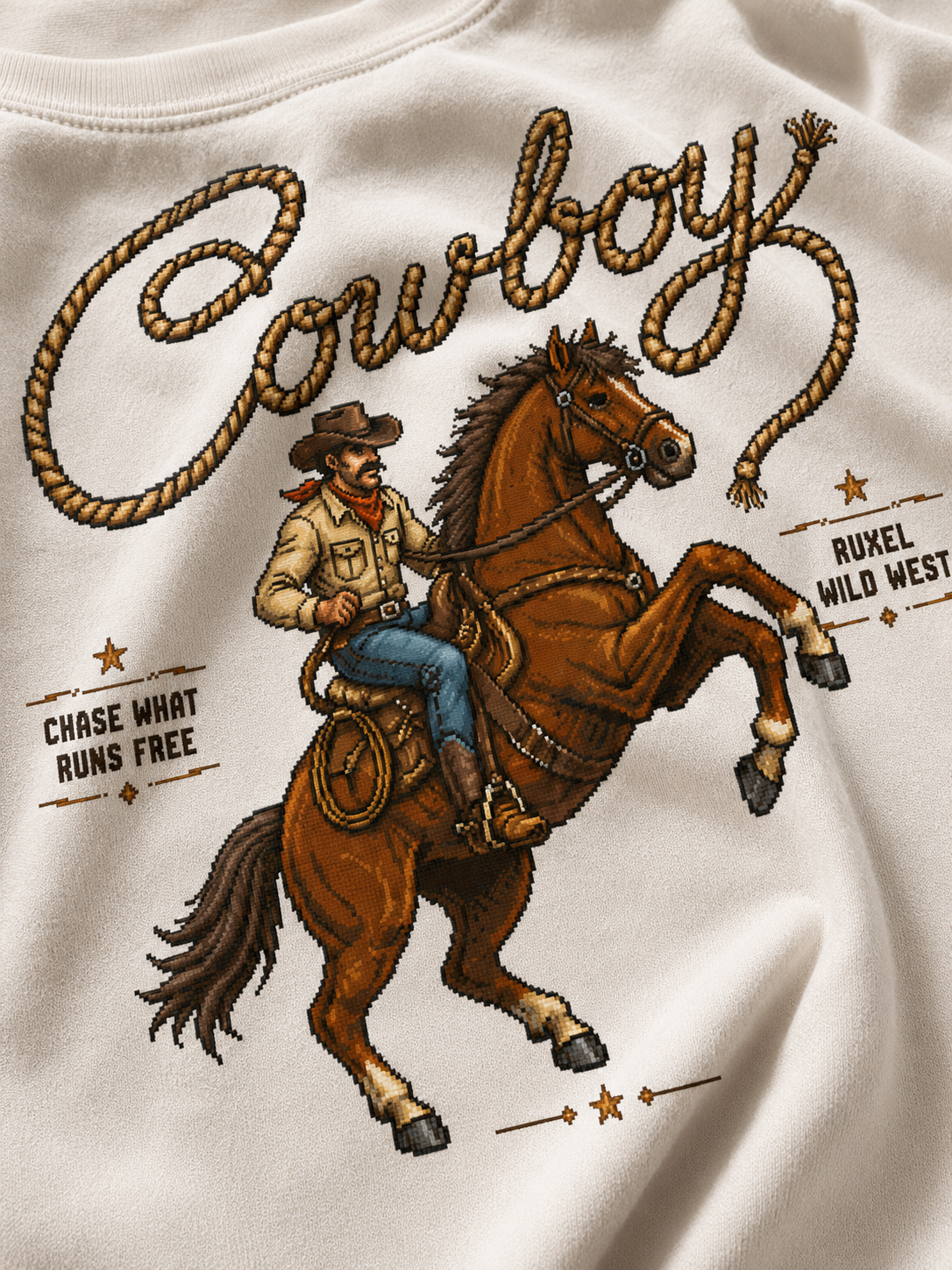 Close-up of the Chase What Runs Free rope-script and cowboy print on Ruxel garment-dyed cotton