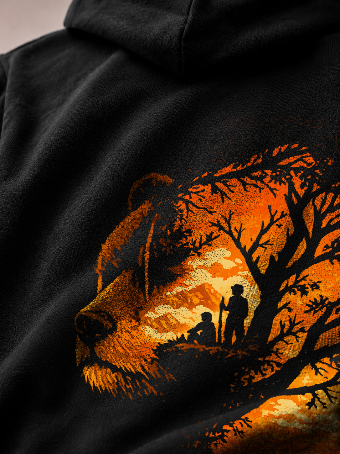 Close-up of the Stay Wild bear and sunset forest print on a Ruxel Void Black hoodie