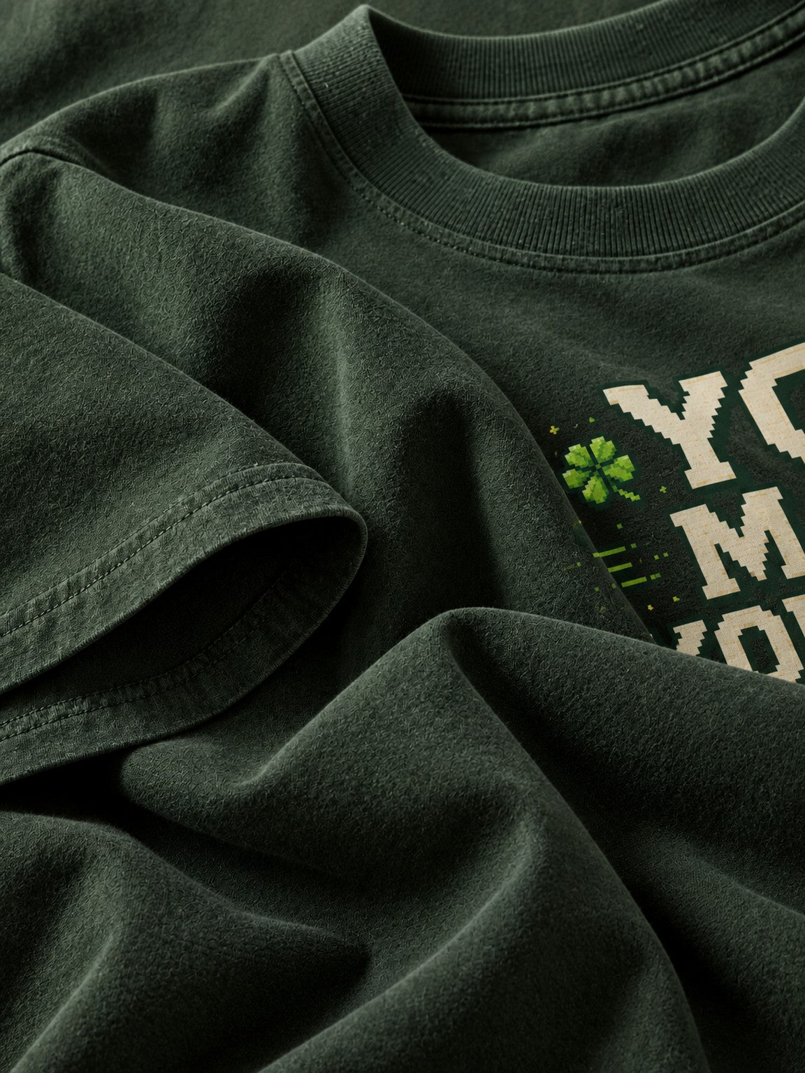 Close-up of the garment-dyed Clover Green heavyweight cotton fabric and sleeve on the Ruxel graphic tee