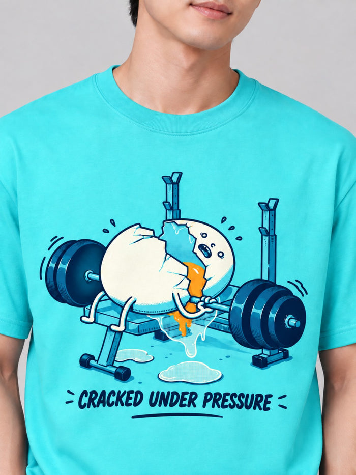 Close-up of the funny cracked egg weightlifting artwork on the Electric Lagoon heavyweight tee