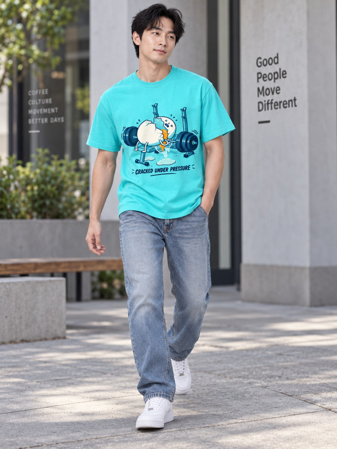 Male model walking in the Cracked Under Pressure Electric Lagoon heavyweight graphic tee