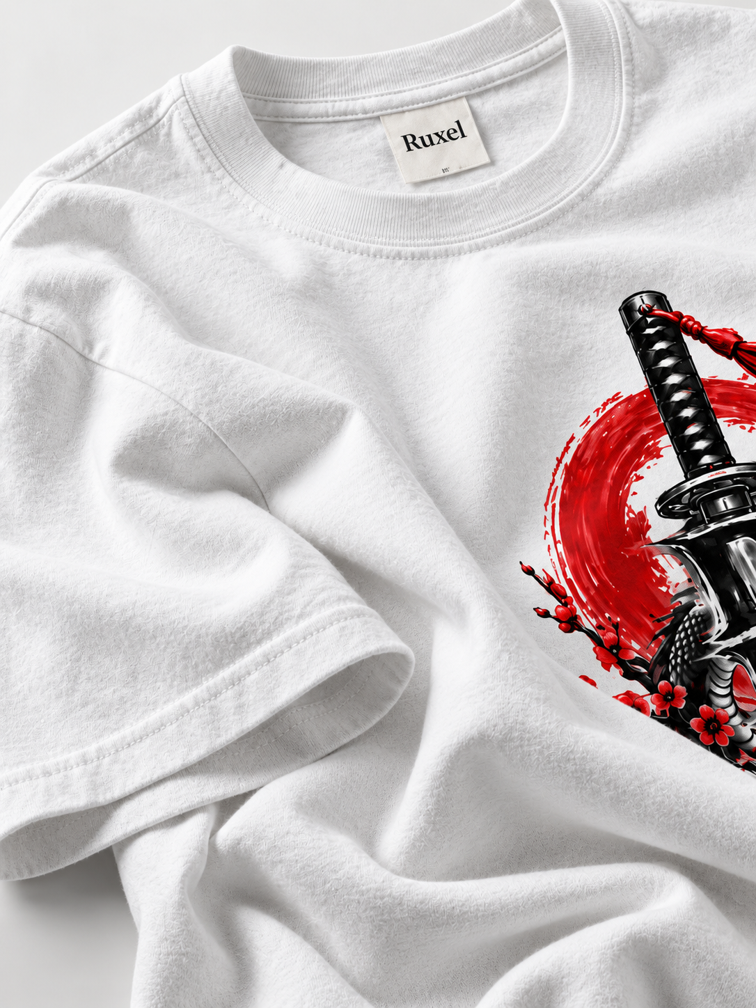 Close-up of white heavyweight cotton fabric and the Ruxel neck label on the Destiny graphic tee