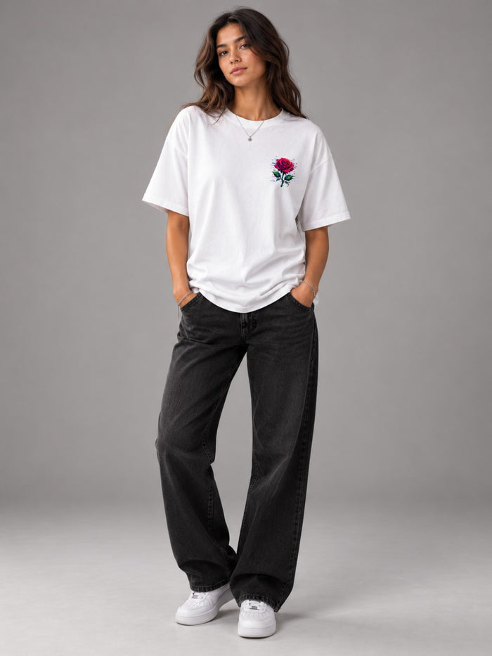 Woman wearing the Ruxel Glitch Rose heavyweight tee in Vintage White, front view with small pixel rose chest print