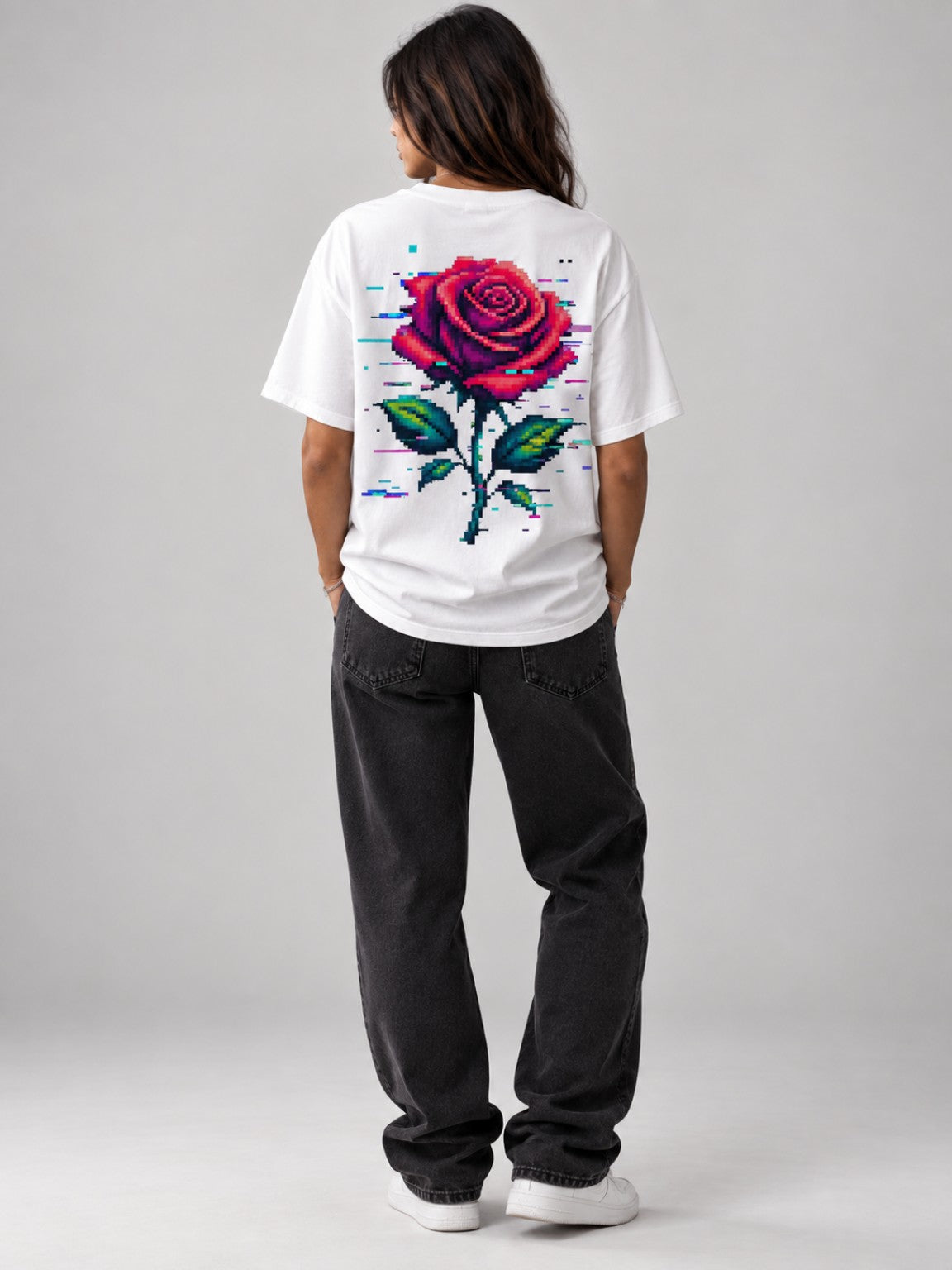 Woman wearing the Ruxel Glitch Rose heavyweight tee in Vintage White, back view with oversized red pixel rose graphic
