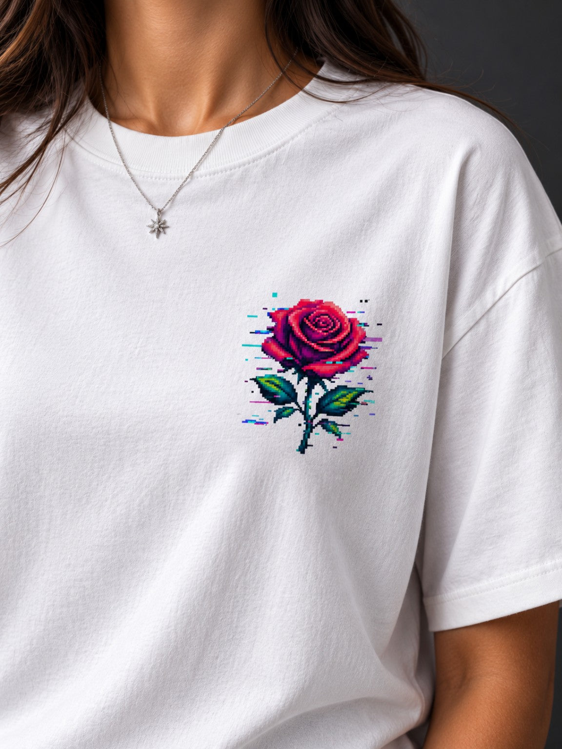 Close-up of the small red Glitch Rose pixel chest graphic on a Vintage White heavyweight tee