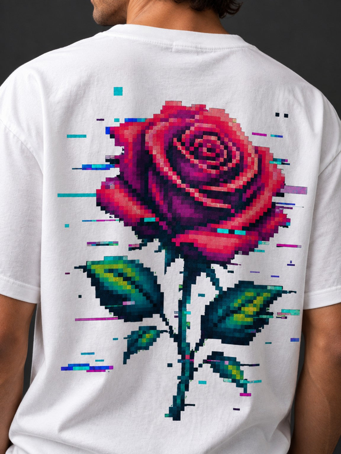 Close-up back view of a man wearing the Vintage White Glitch Rose tee with oversized pixel rose artwork