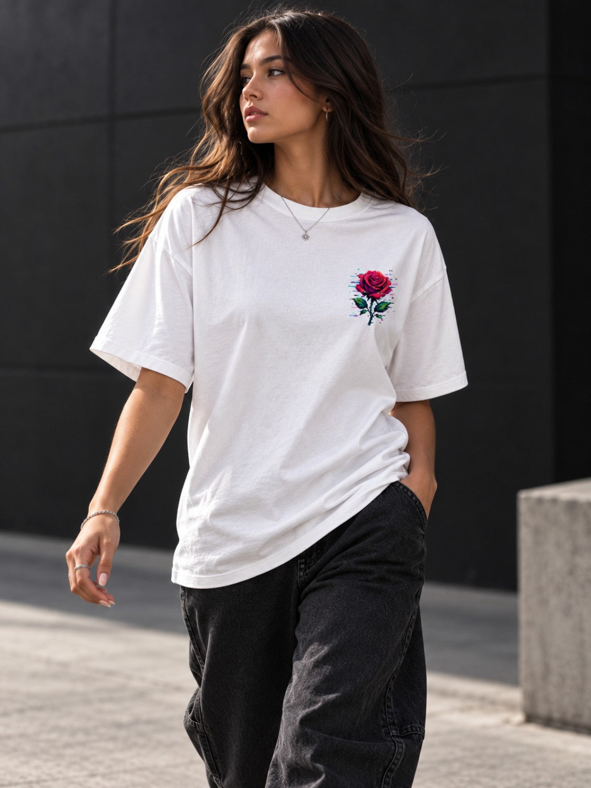 Woman walking in the Ruxel Glitch Rose heavyweight tee, front lifestyle view with pixel rose chest graphic