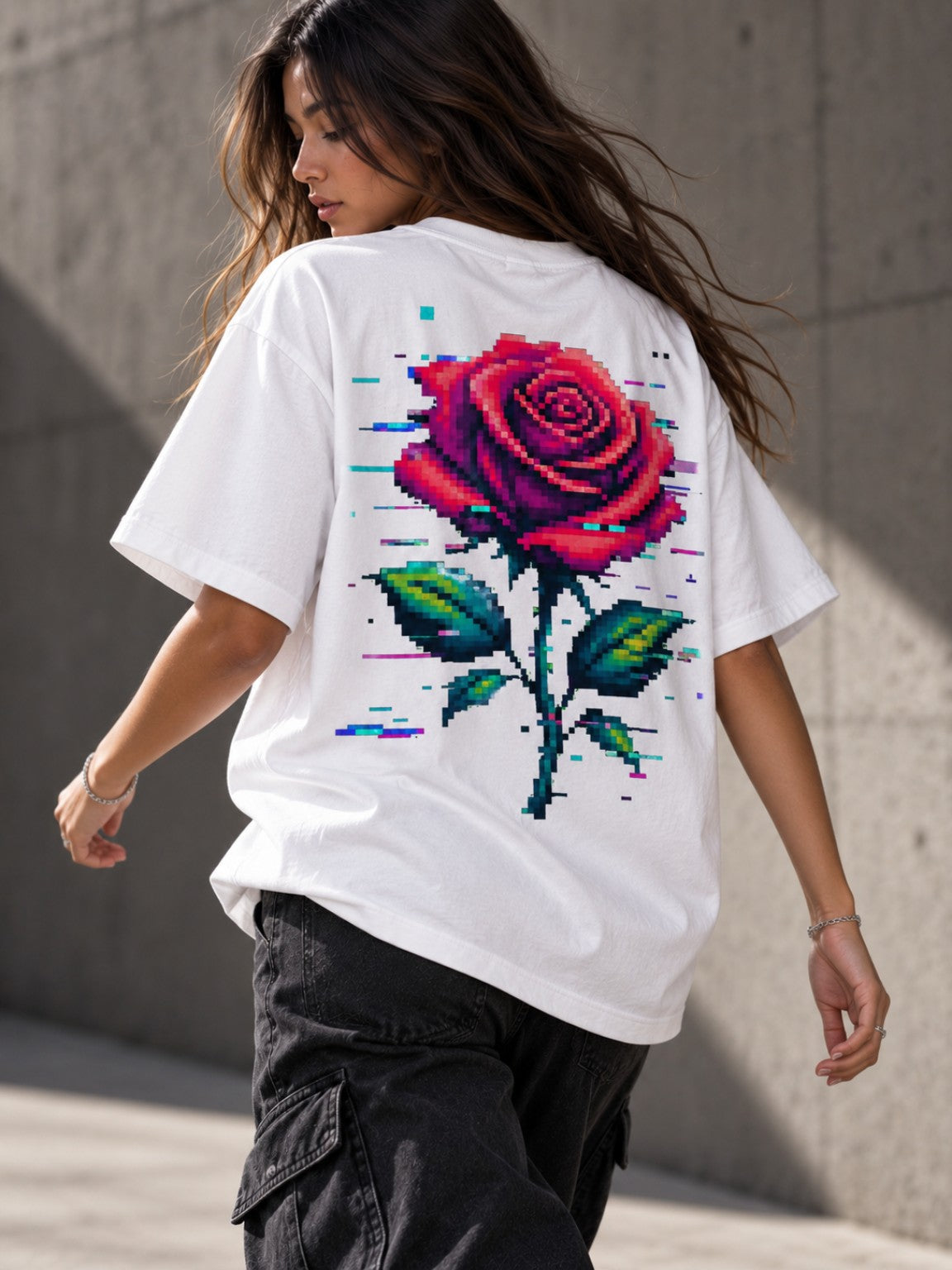 Woman wearing the Ruxel Glitch Rose heavyweight tee, back lifestyle view with oversized pixel rose artwork