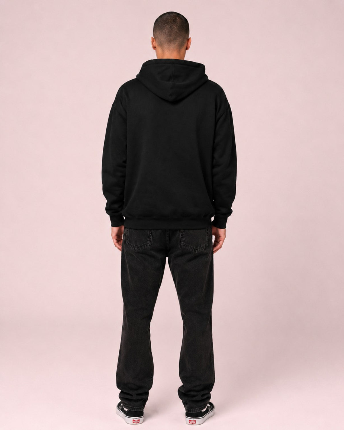 Back view of a male model wearing the Ruxel Good Luck Loading Void Black heavyweight hoodie with a plain back