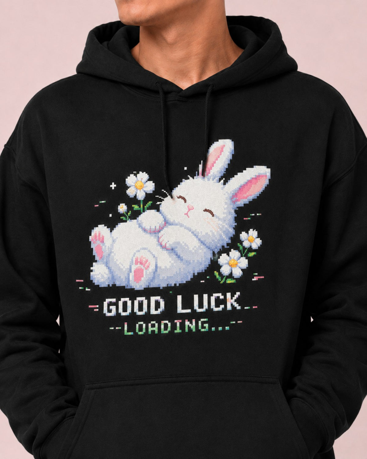 Close-up front view of the Ruxel Good Luck Loading Void Black hoodie showing the sleeping pixel bunny, daisies and loading text