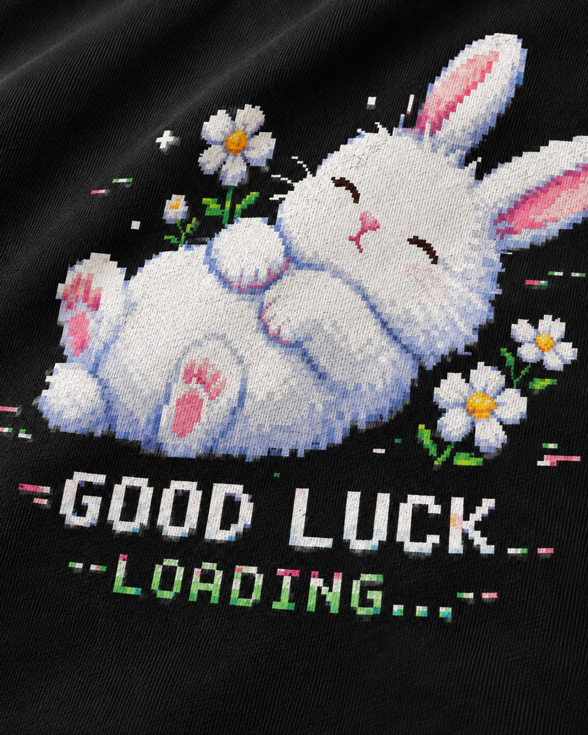 Macro detail of the Good Luck Loading pixel bunny and daisy print on black heavyweight hoodie fabric