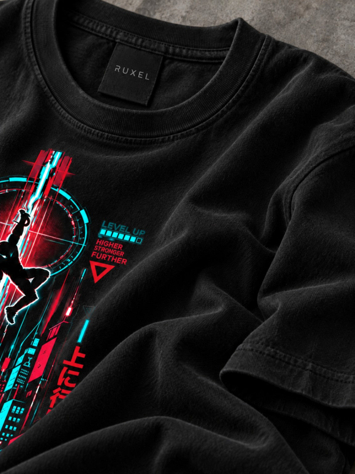 Close-up of the Ruxel neck label and Level Up artwork on the Signal Black heavyweight tee