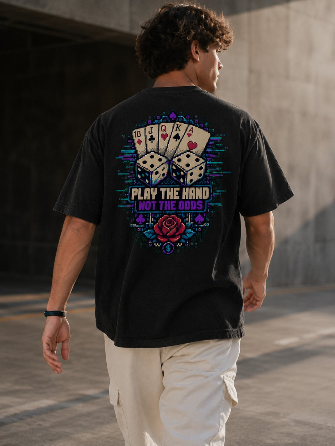 Ruxel Luck.exe Play the Hand Pixel Art Tee in motion, back view showing the oversized drape and full royal flush, dice, rose and Play the Hand Not the Odds graphic