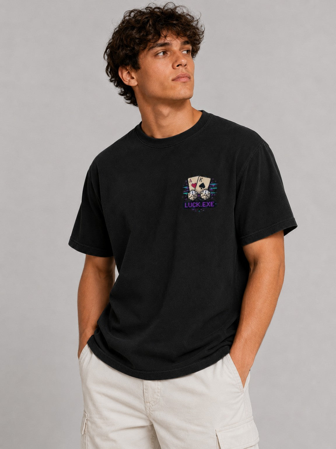 Three-quarter front view of the Ruxel Luck.exe Play the Hand tee showing the oversized fit, garment-dyed black fabric and chest print