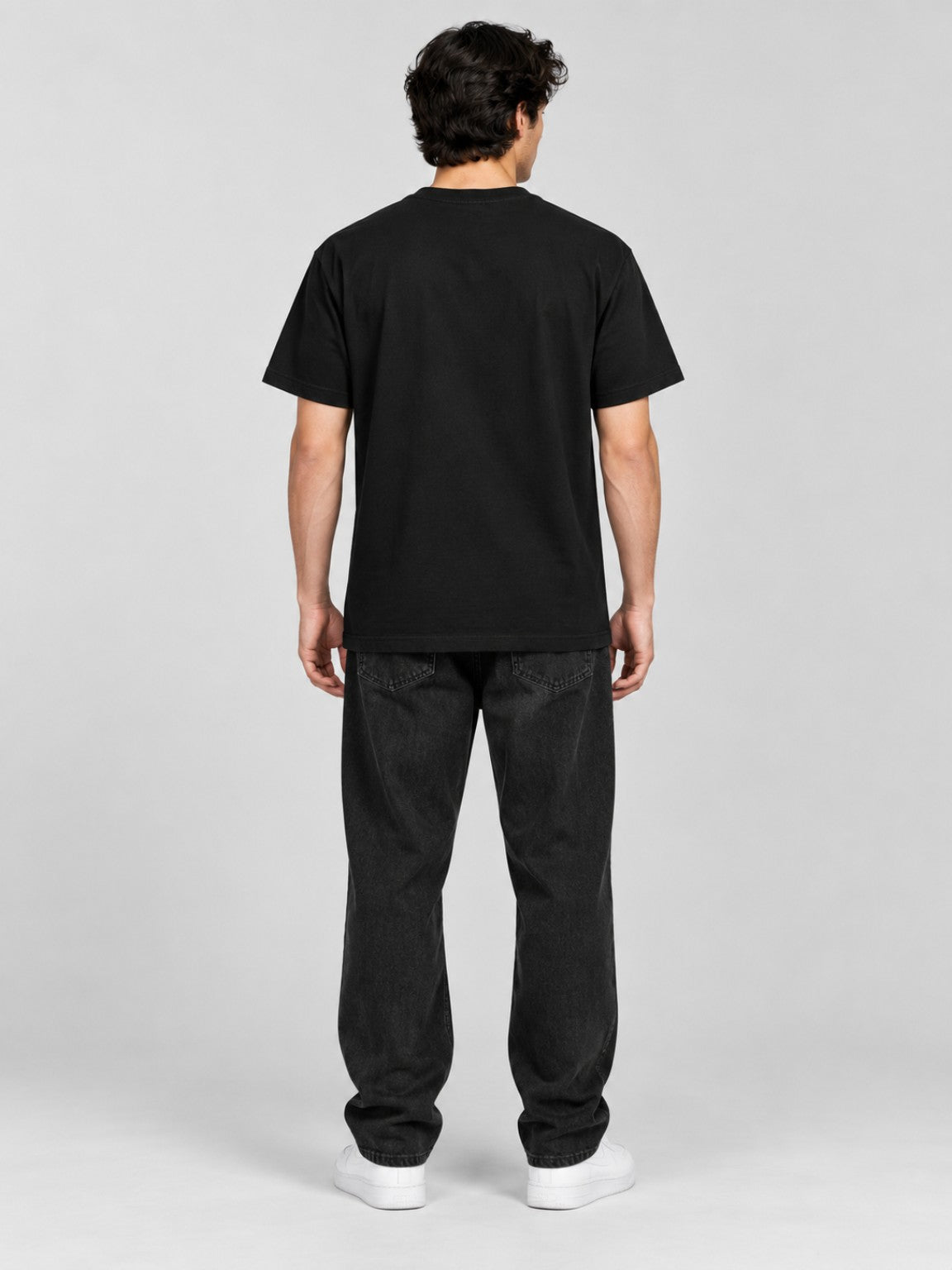 Male model wearing the Tethered Souls Eclipse Black heavyweight tee, plain back studio view