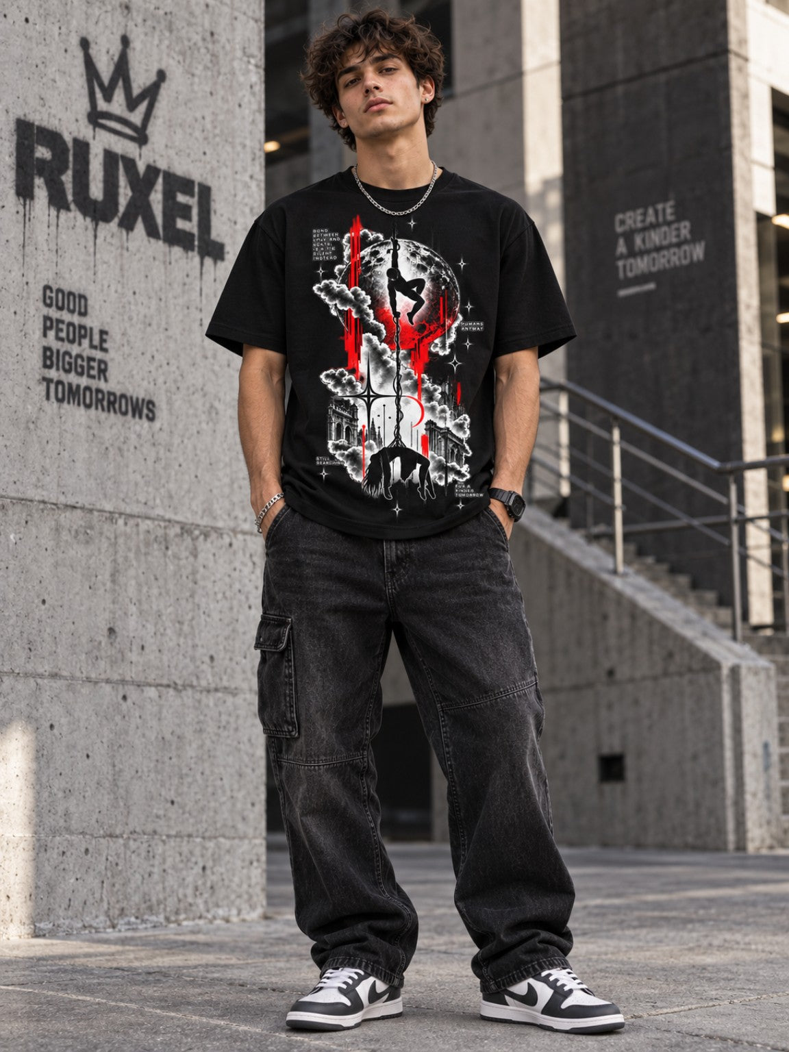 Male model wearing the Tethered Souls gothic moon graphic tee in an urban concrete setting